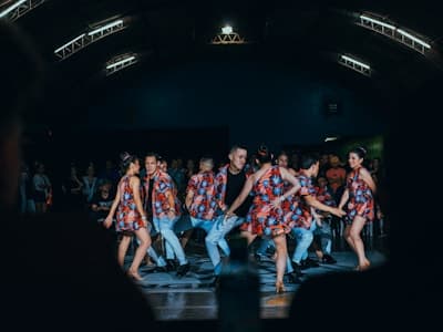 A smiling dancer mid-movement in an expressive Bollywood pose